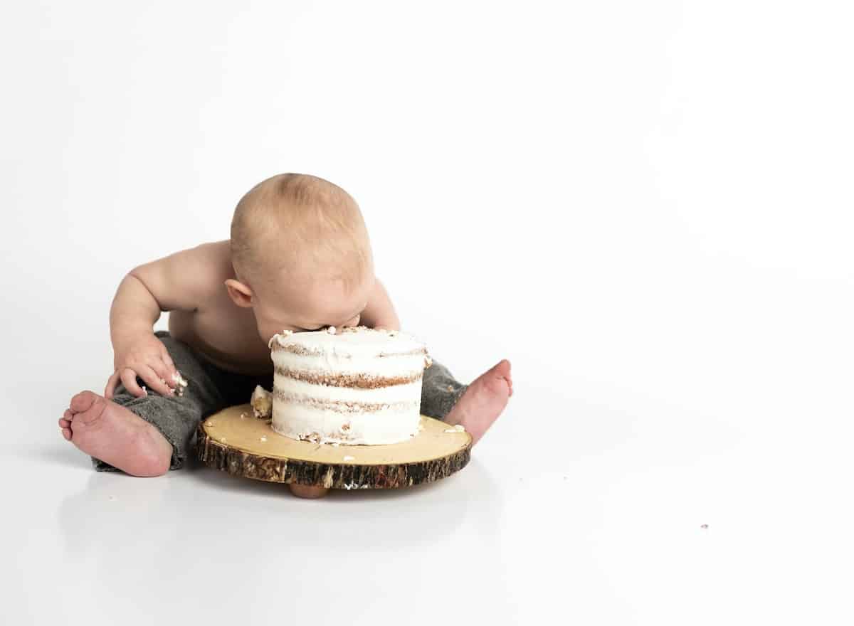 1 year old with head in birthday cake