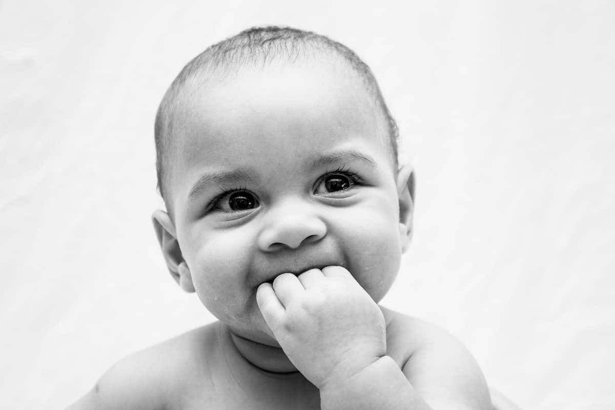 cute baby eating its hand