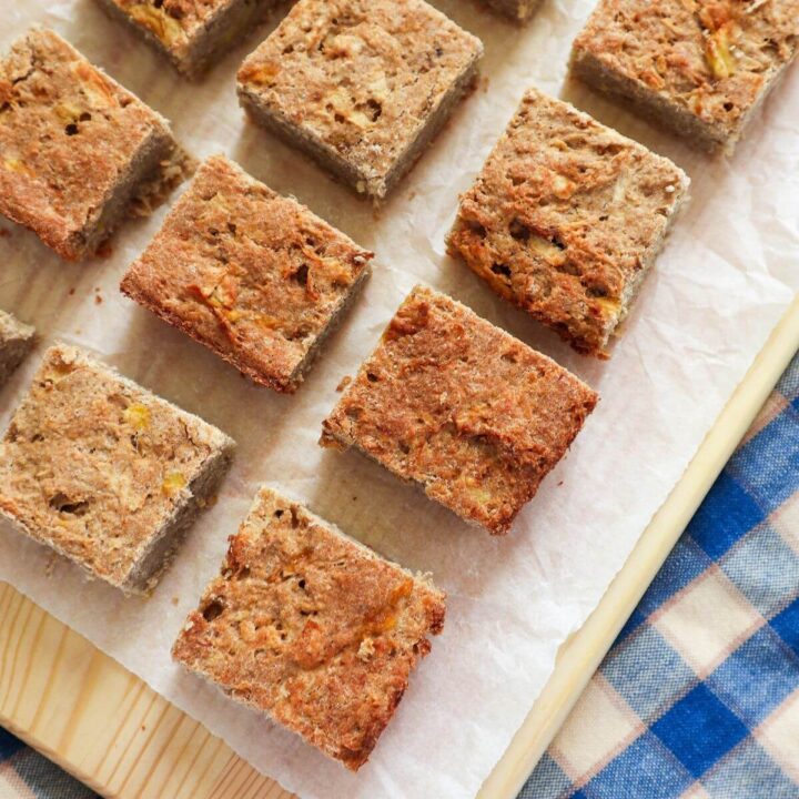 Sugar free gluten free apple oat cake for baby on white parchment paper.