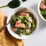 Pesto pasta topped with salmon.