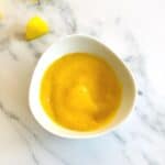 mango puree for baby in a white bowl