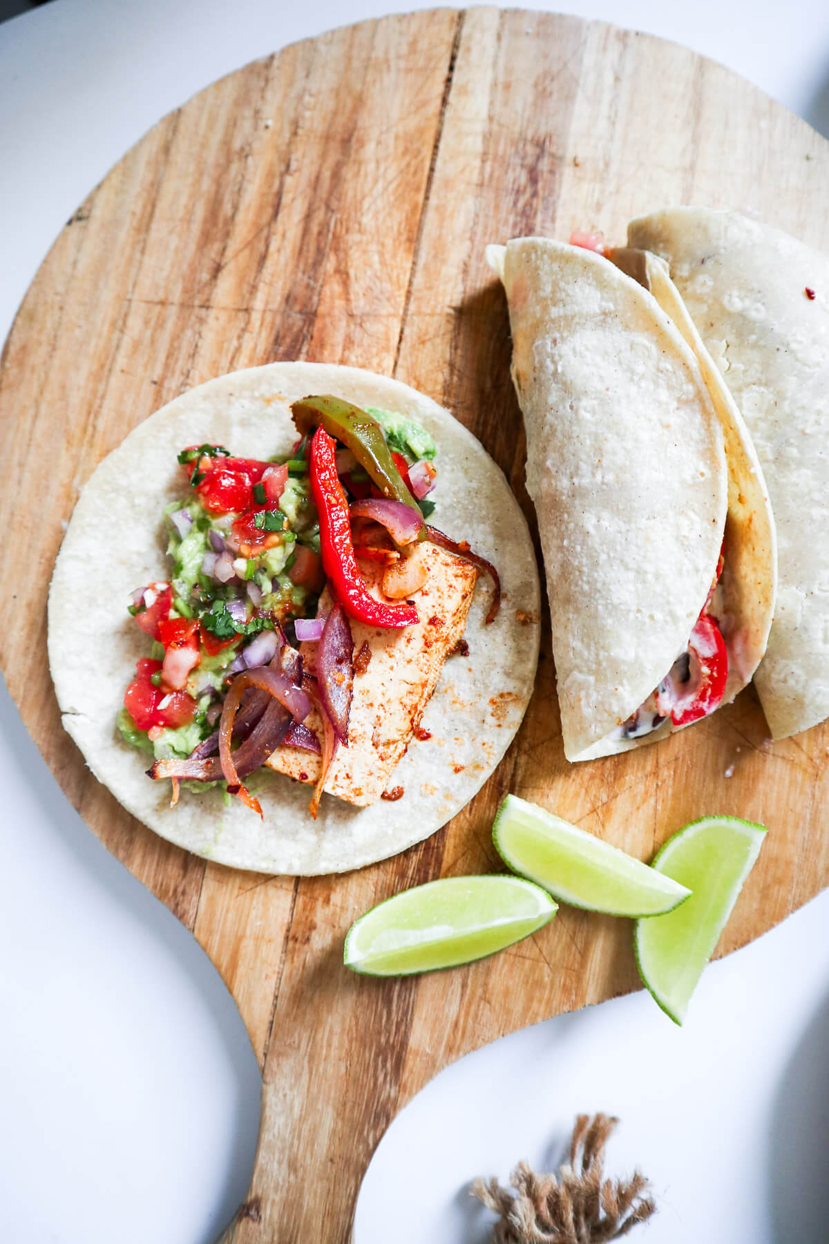 Fajitas on a wooden board with limes