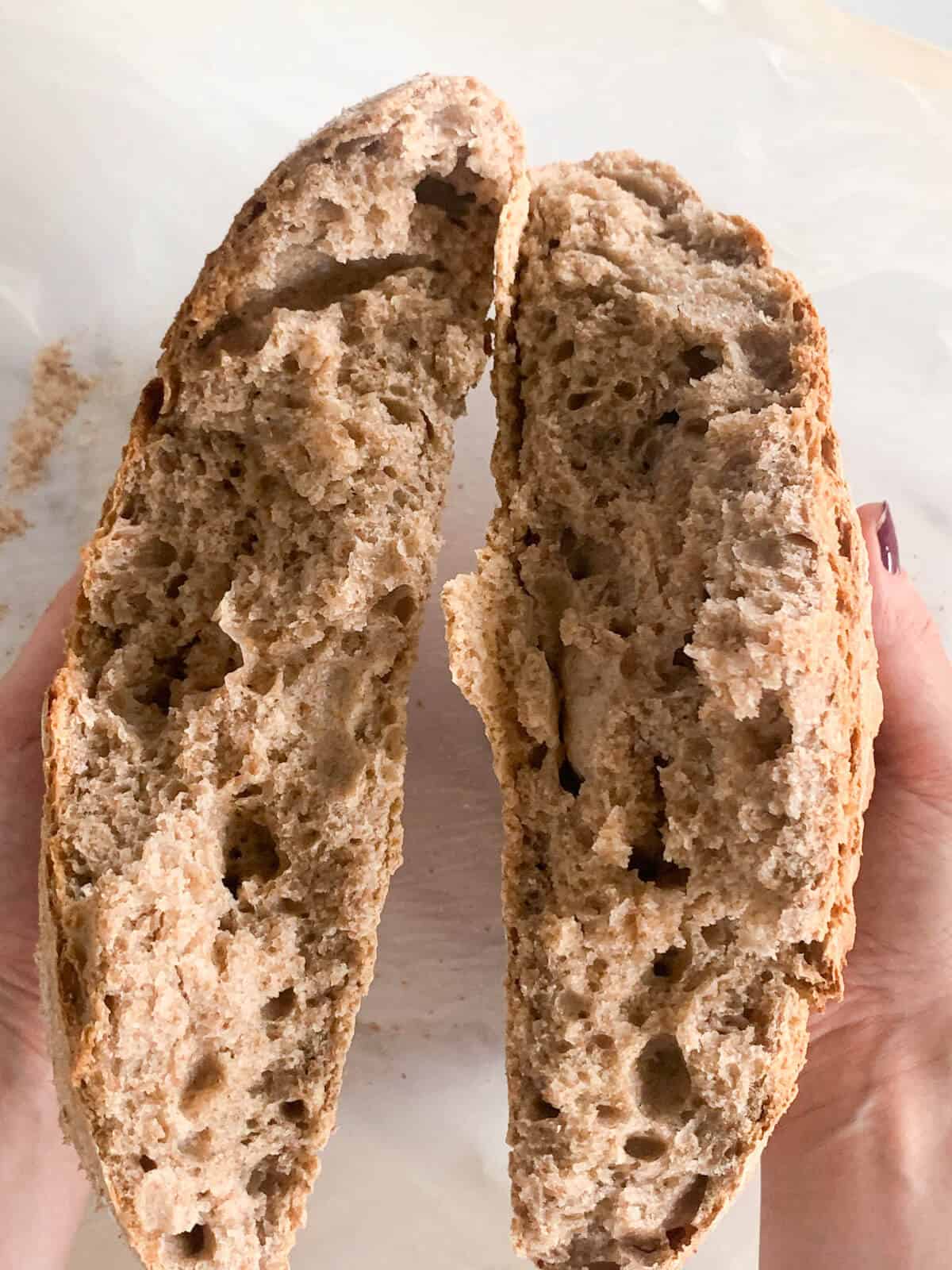 Wholewheat no-knead bread broken in half 