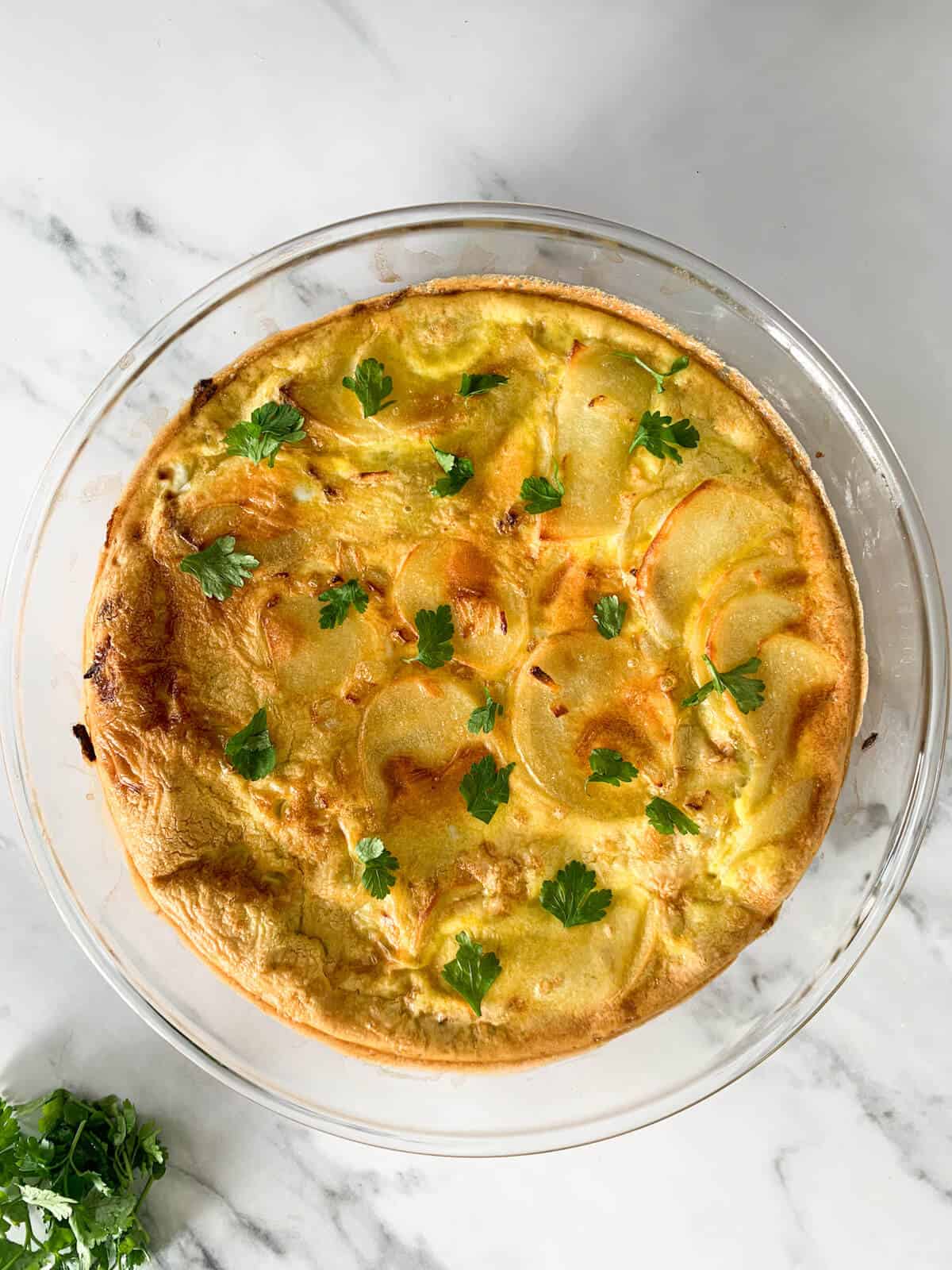 Oven-baked Spanish tortilla with sprinkled parsley