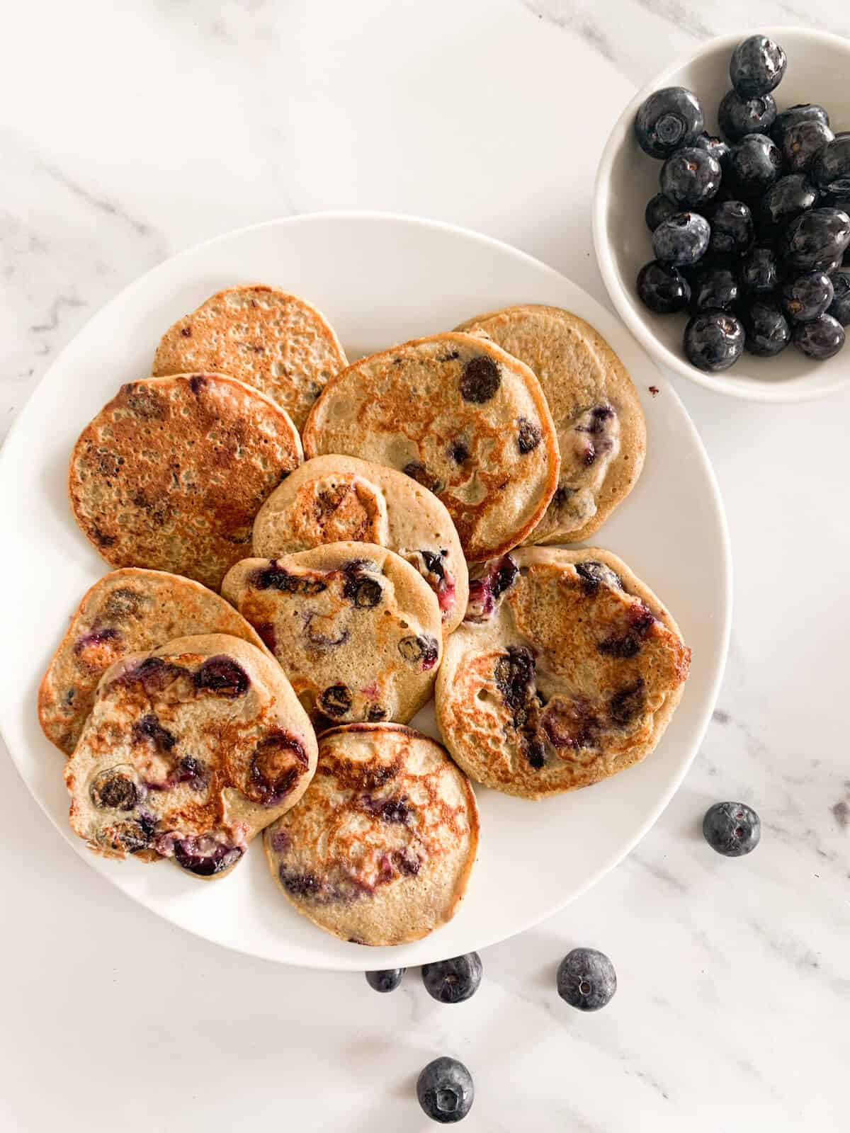 Blueberry Pancakes on a plate with a side of blueberries for baby & toddler 