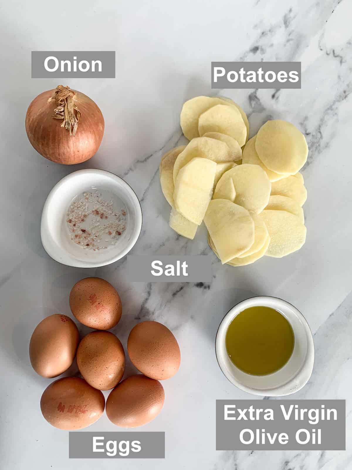 ingredients for oven-baked Spanish tortilla - onion, potato, salt, eggs and extra virgin olive oil 