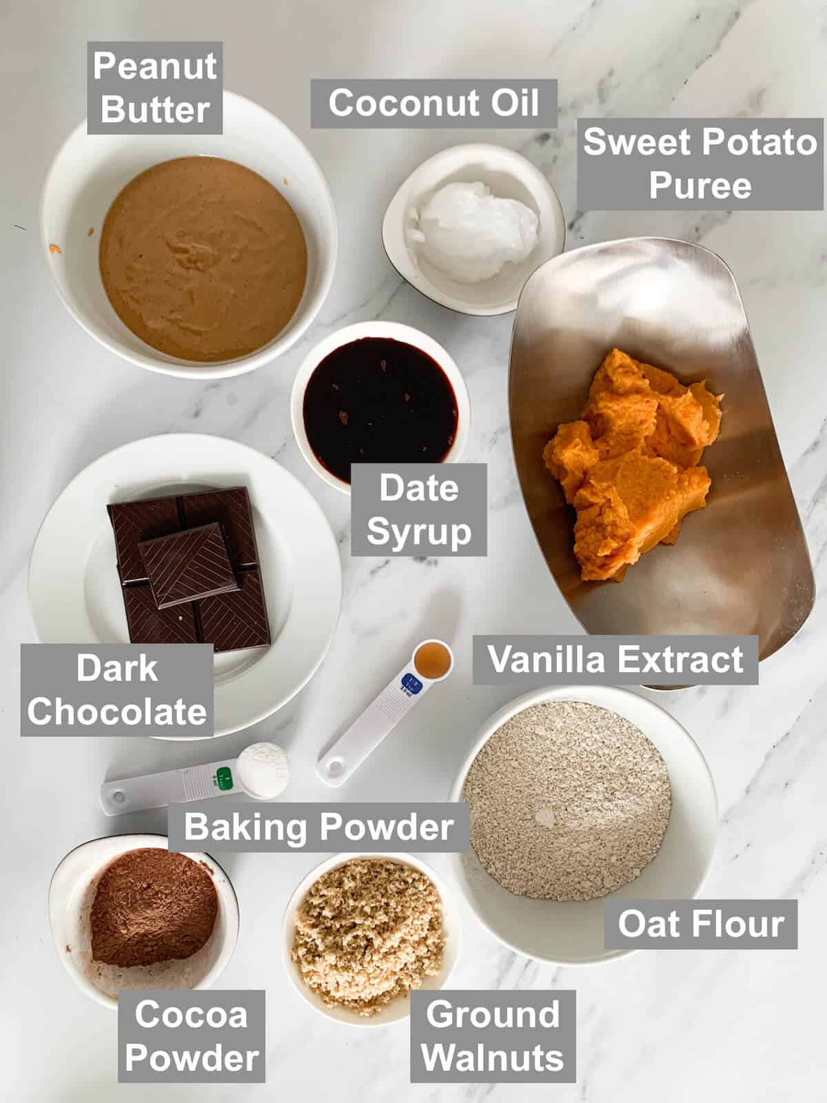Ingredients for sweet potato brownies on a marble background