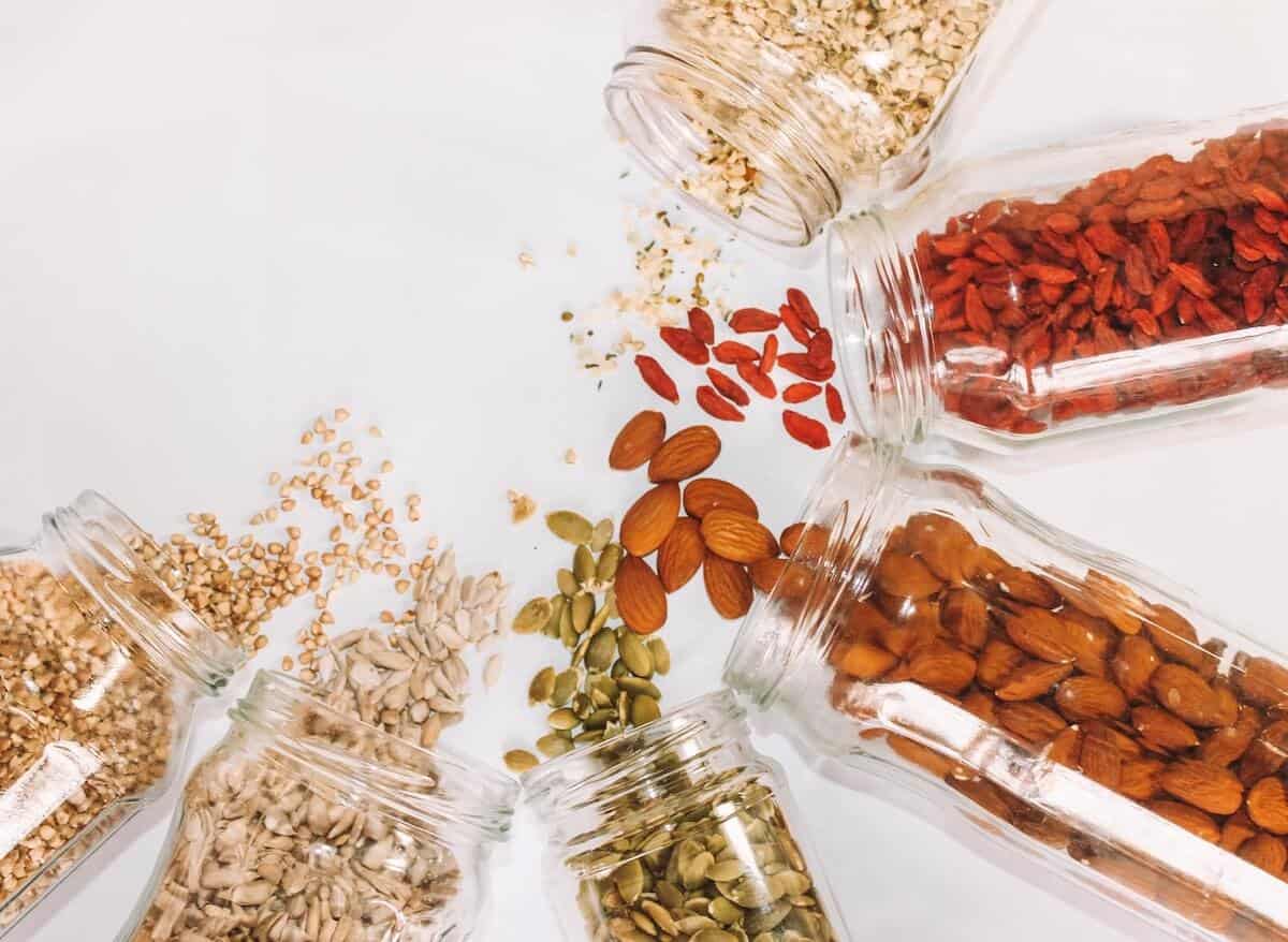 Grains, nuts and dried fruits on white background