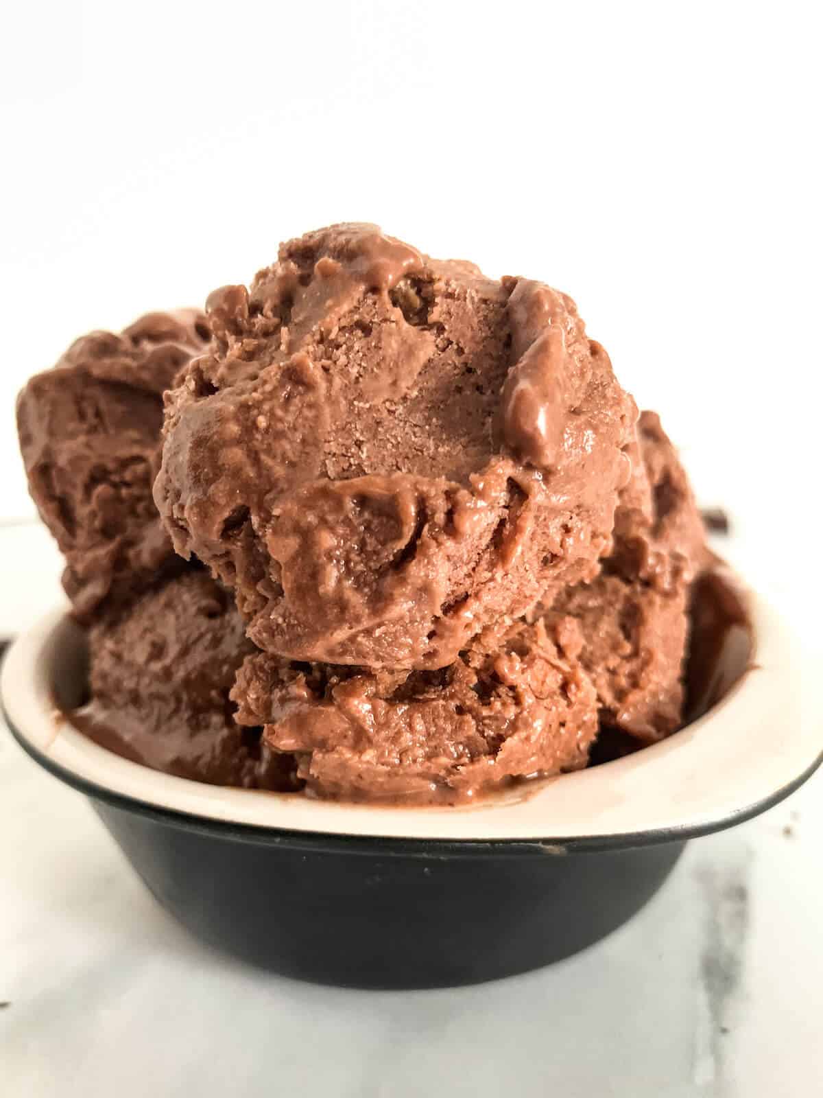 chocolate peanut butter ice cream in a black and white ceramic bowl 