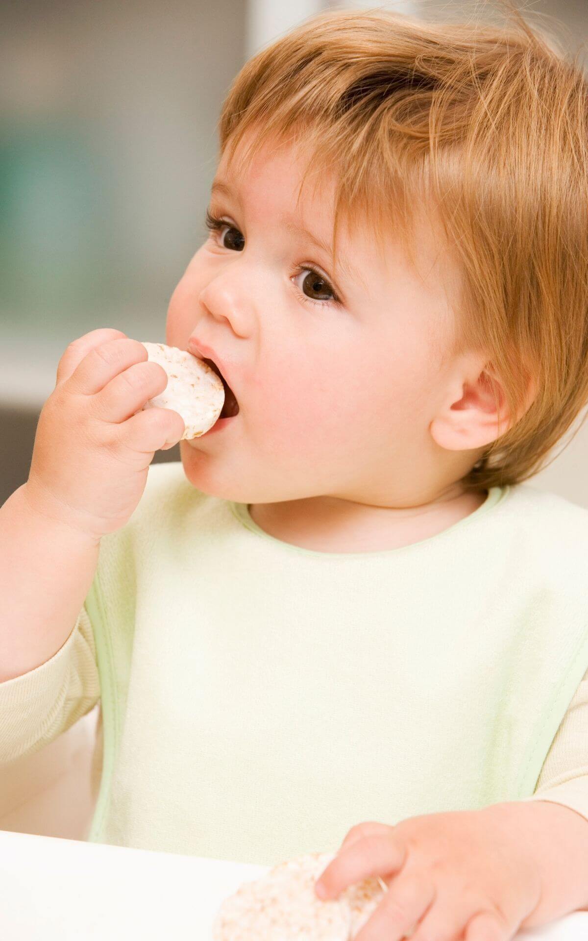 baby eating rice cake 