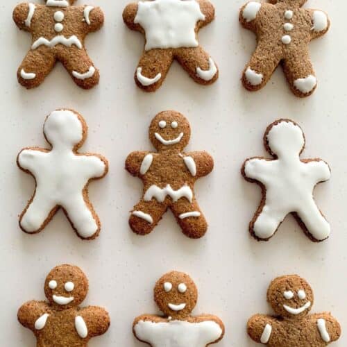 Decorated gingerbread men cookies on white background