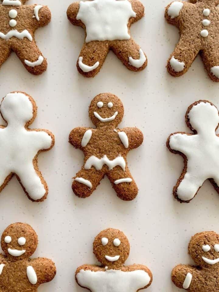 Decorated gingerbread men cookies on white background
