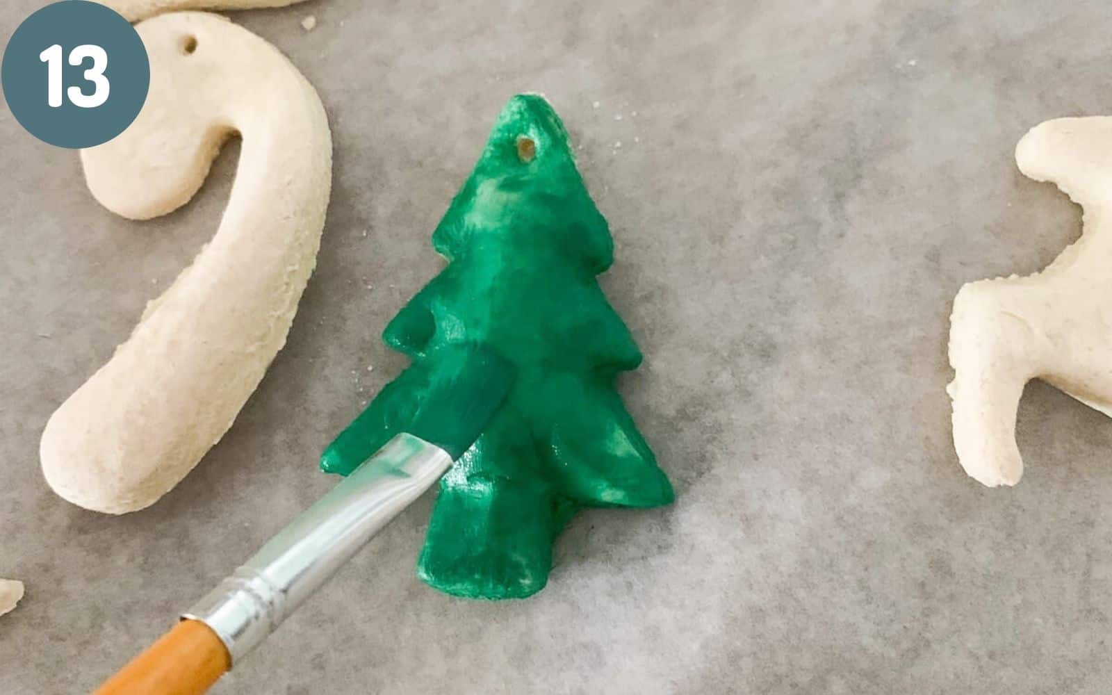 painting salt dough Christmas tree in green
