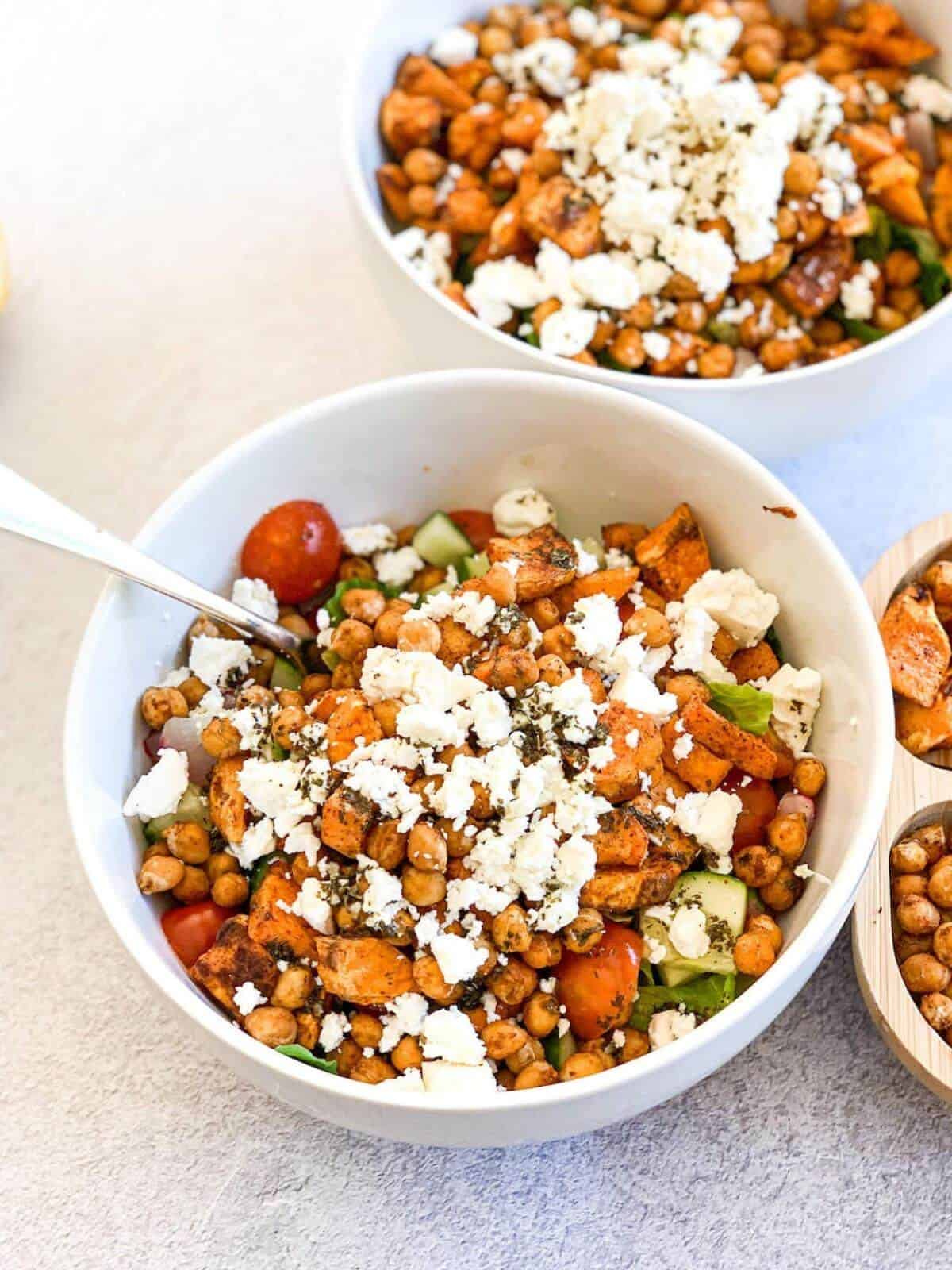 sweet potato salad in a white bowl with metal fork inside 