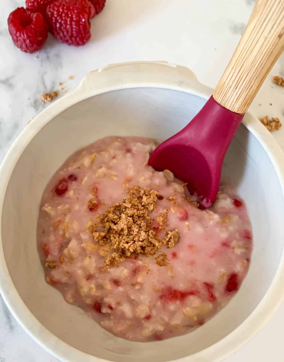 Oatmeal in a silicone bowl, sprinkled on top with walnuts