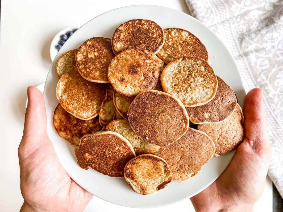 pancakes on a pile on a held plate