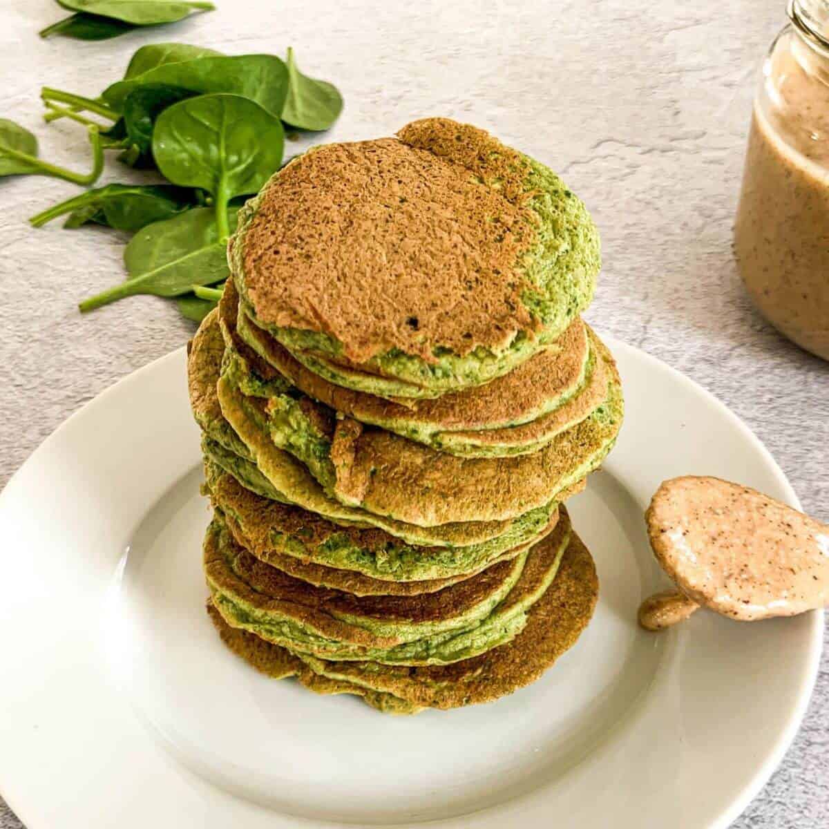 Banana spinach pancakes for baby stacked on a plate