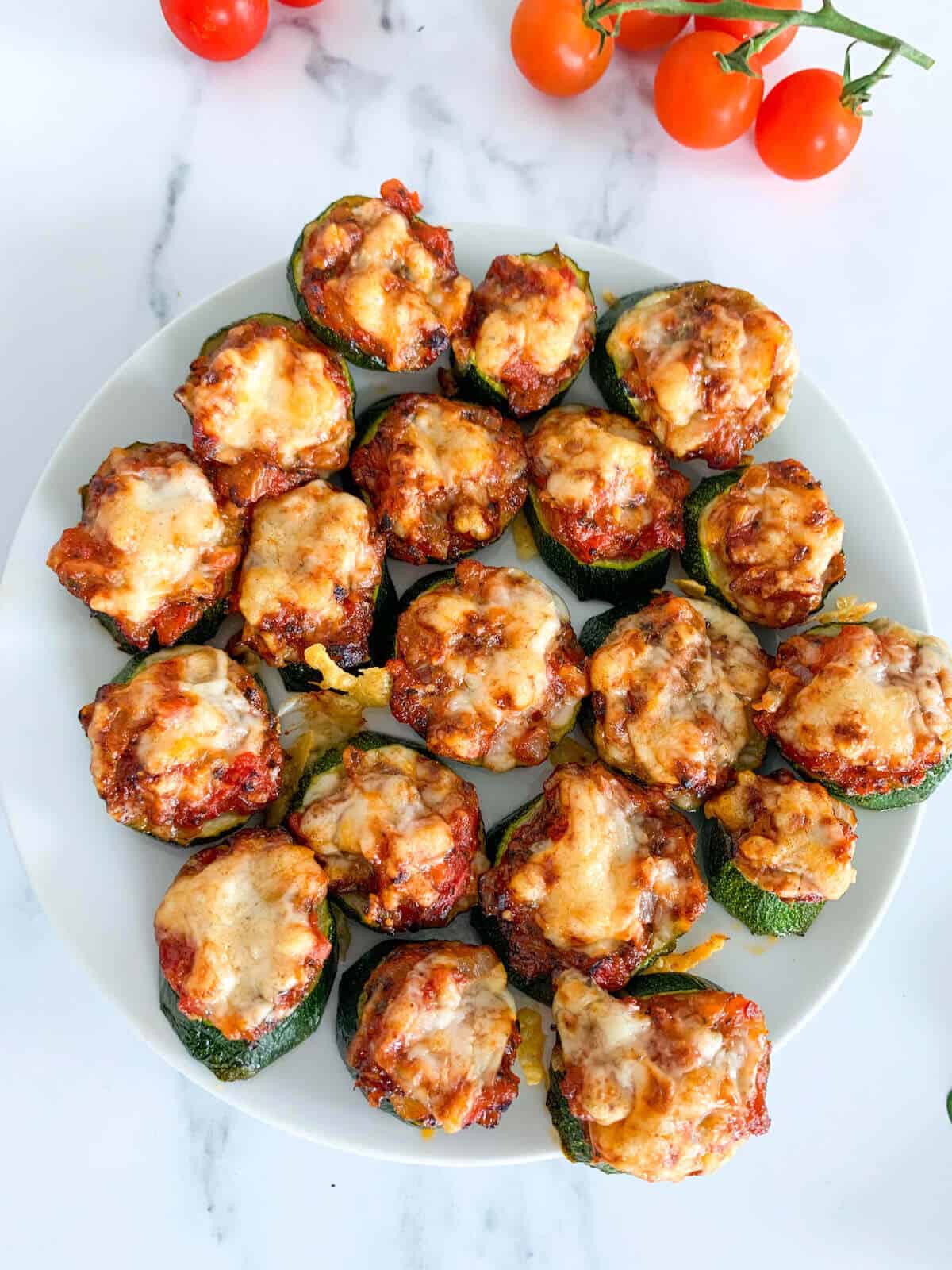 Lots of Mini Zucchini Pizza Bites on a plate 