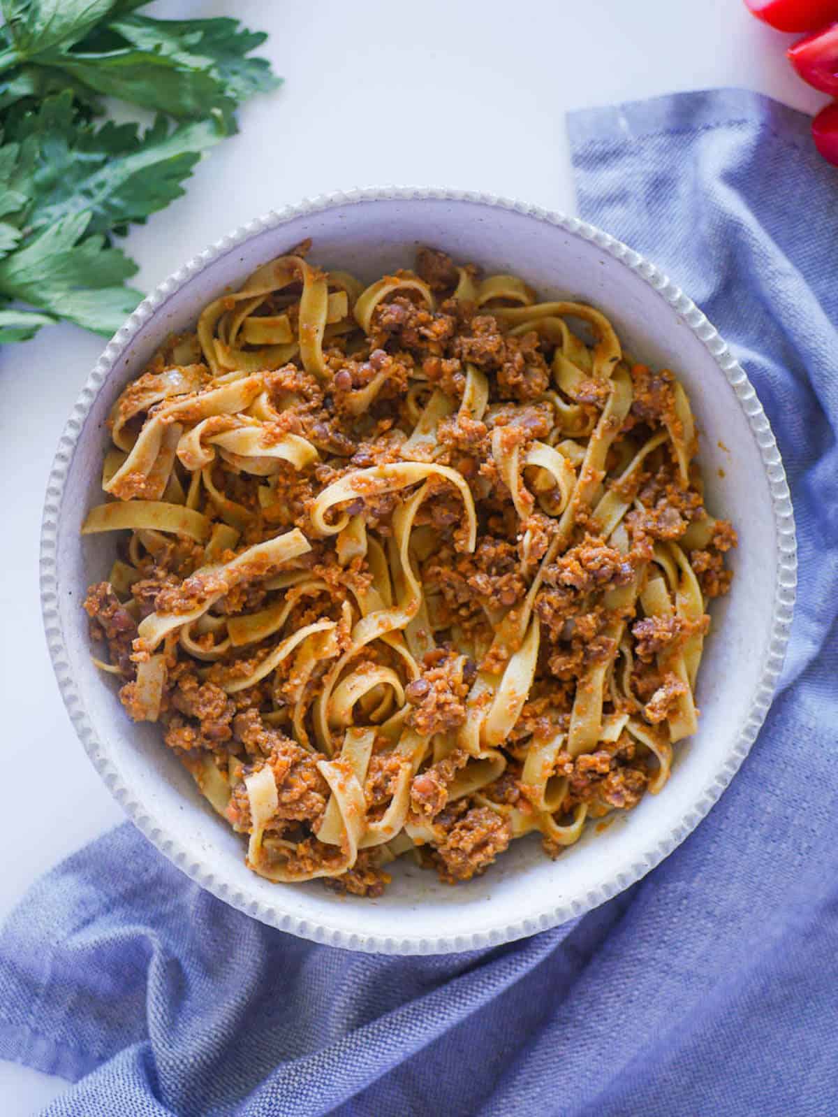 vegan bolognese with pasta in a ceramic bowl
