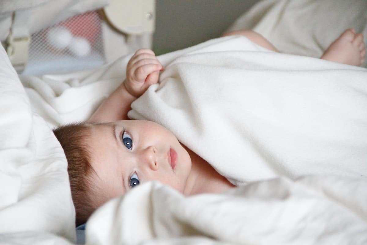 baby in white blanket