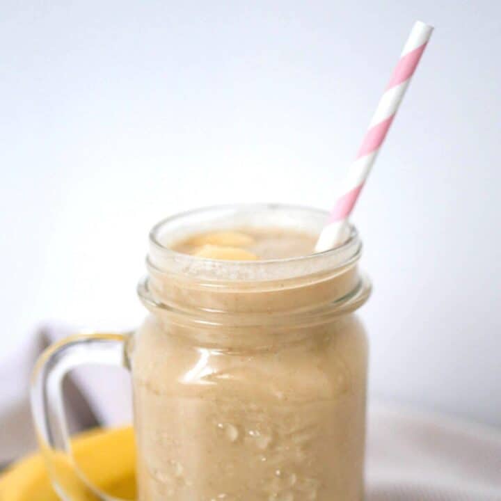 Apple Banana Smoothie in a glass with pink straw