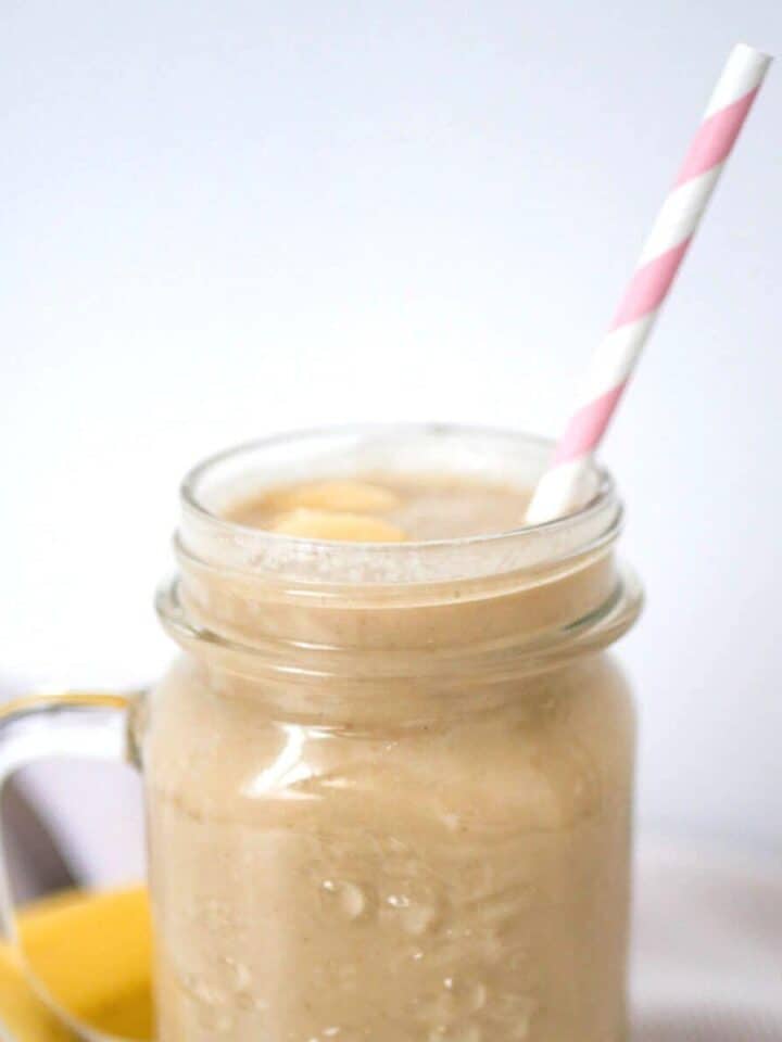 Apple Banana Smoothie in a glass with pink straw