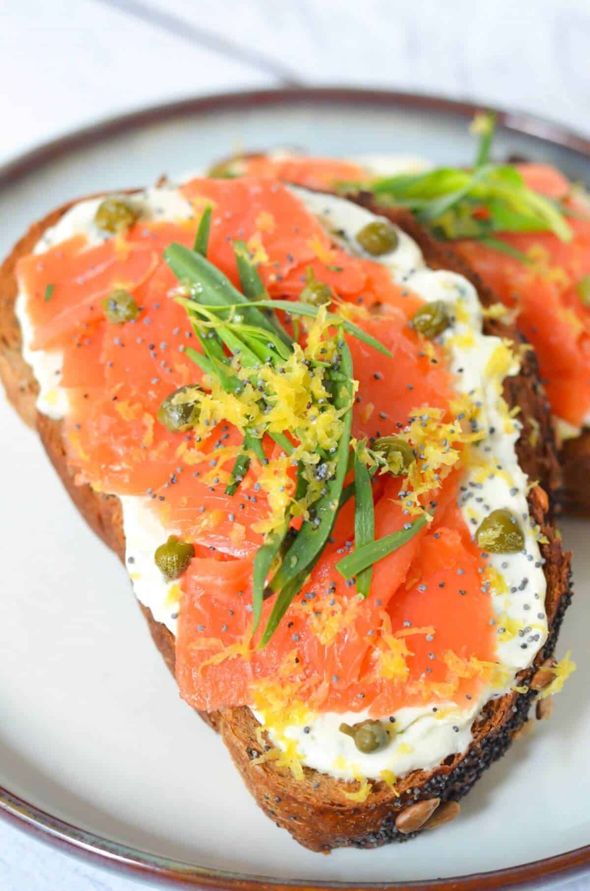 Piece of toast with cream cheese and smoked salmon. 