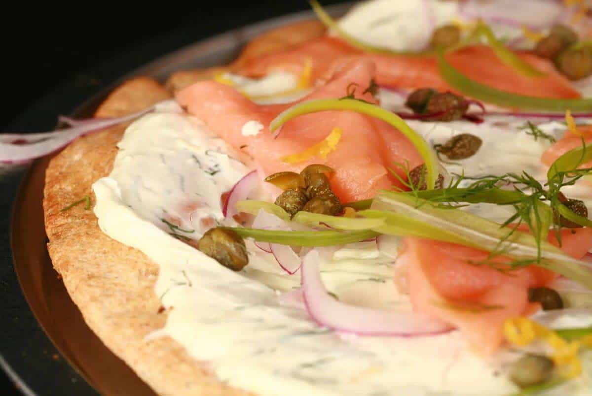 Pizza with cream, smoked salmon and vegetables. 