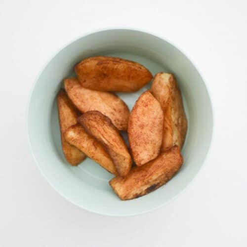 sliced baked apples for baby-led weaning in a bowl