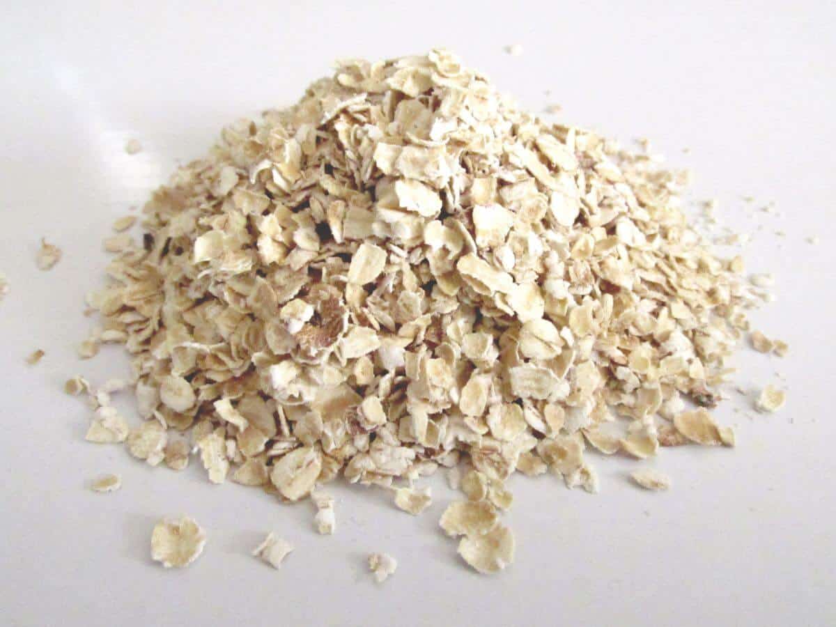 rolled oats pilled on white background 