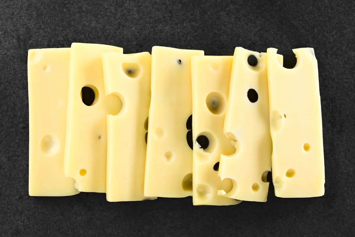 Slices of emmental cheese on a black background