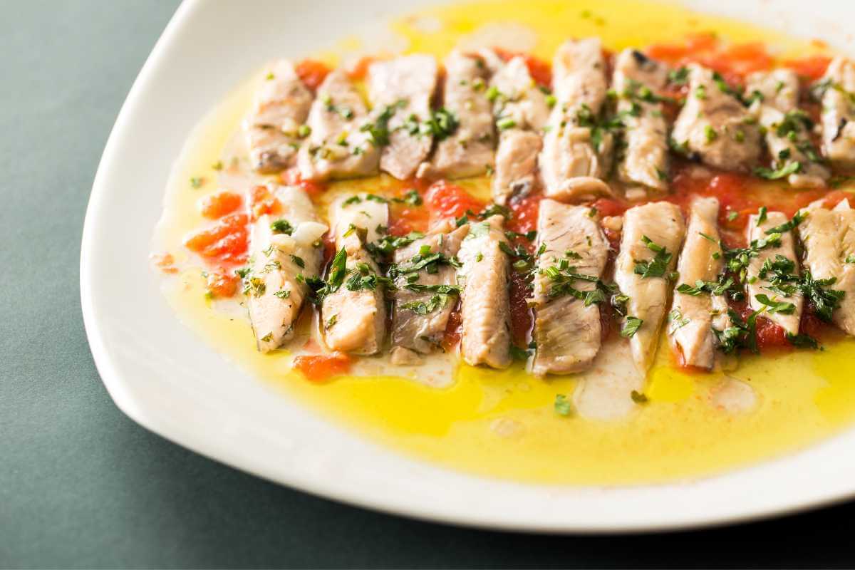 Albacore tuna on a plate marinated with some herbs and olive oil