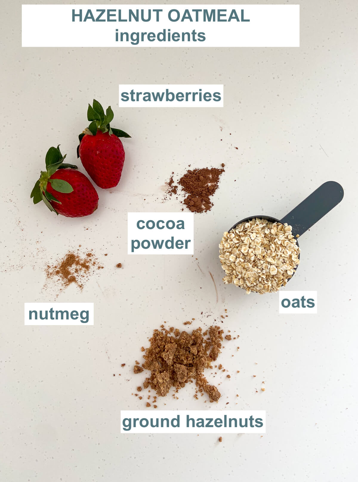 ingredients for baby cereal - oats, strawberries, cocoa powder, nutmeg and ground hazelnuts on a white backgroud