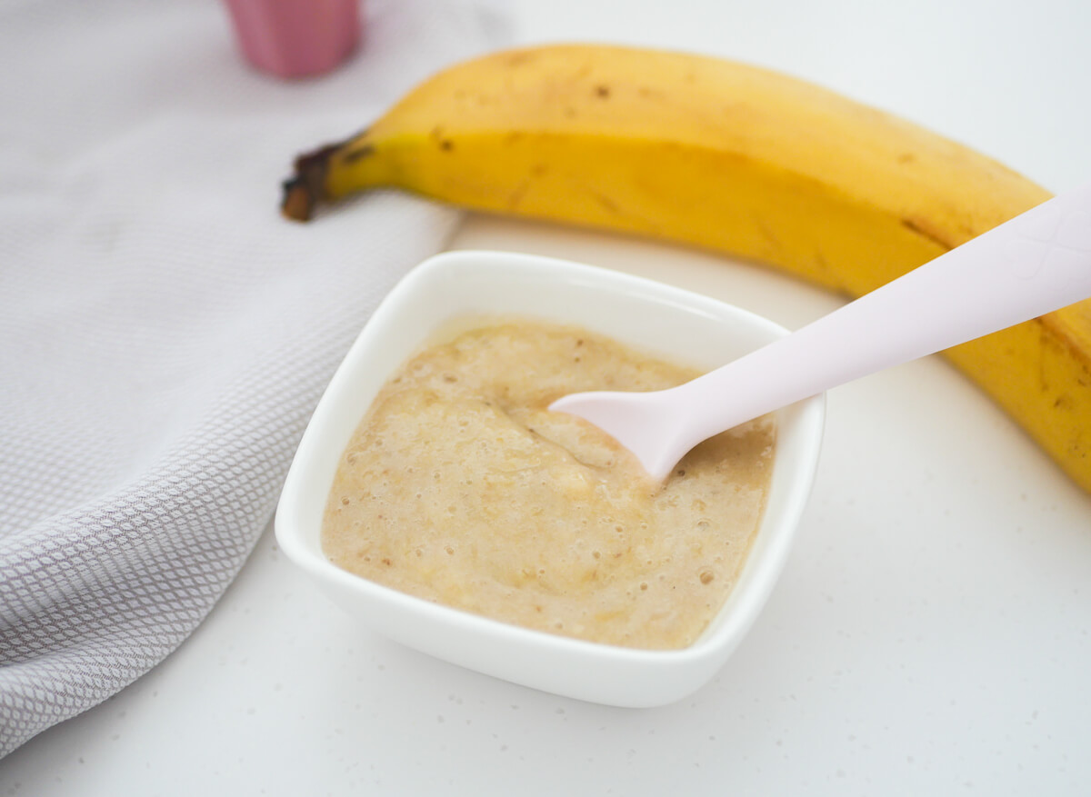 banana puree for baby with spoon dipped in 