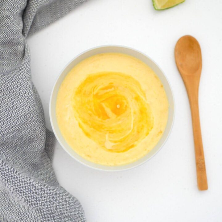 Mango yogurt with wooden spoon