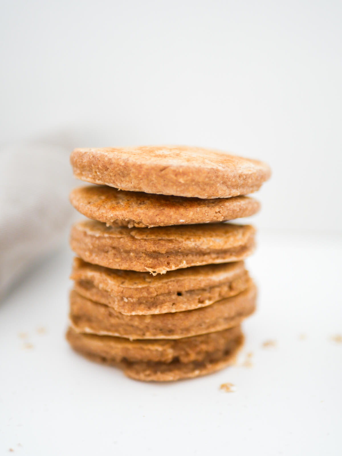 stack of 6 oat flour pancakes with a white background