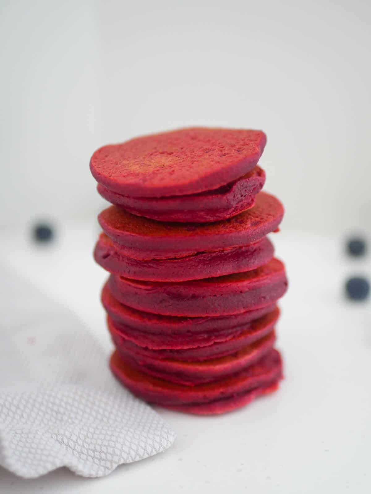 Pink beet pancakes stacked 