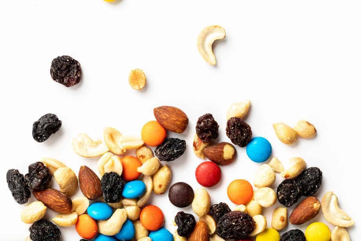 some trail mix scattered onto a table, a perfect beach snack idea