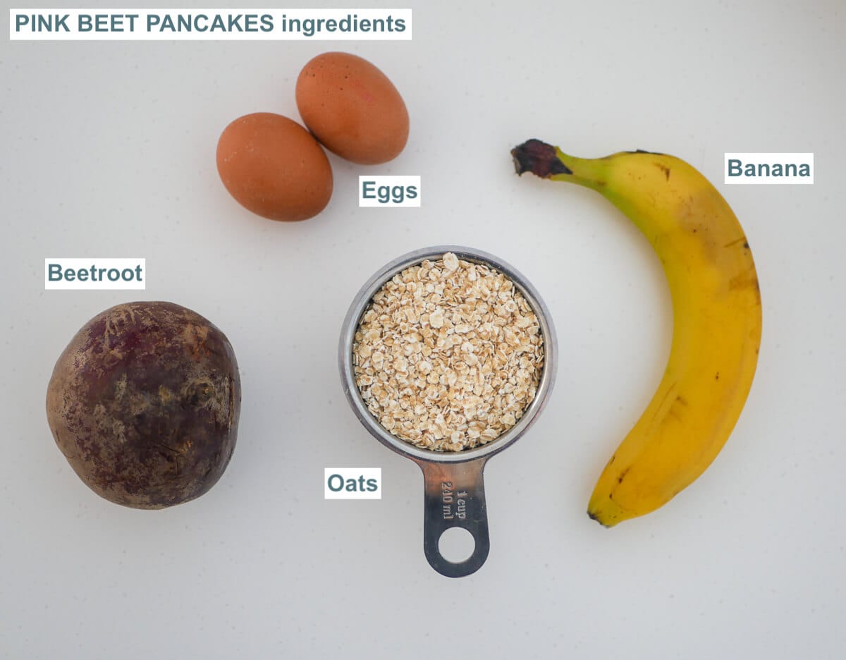 ingredients for pink beet pancakes on a white background - eggs, beetroot, banana, oats 