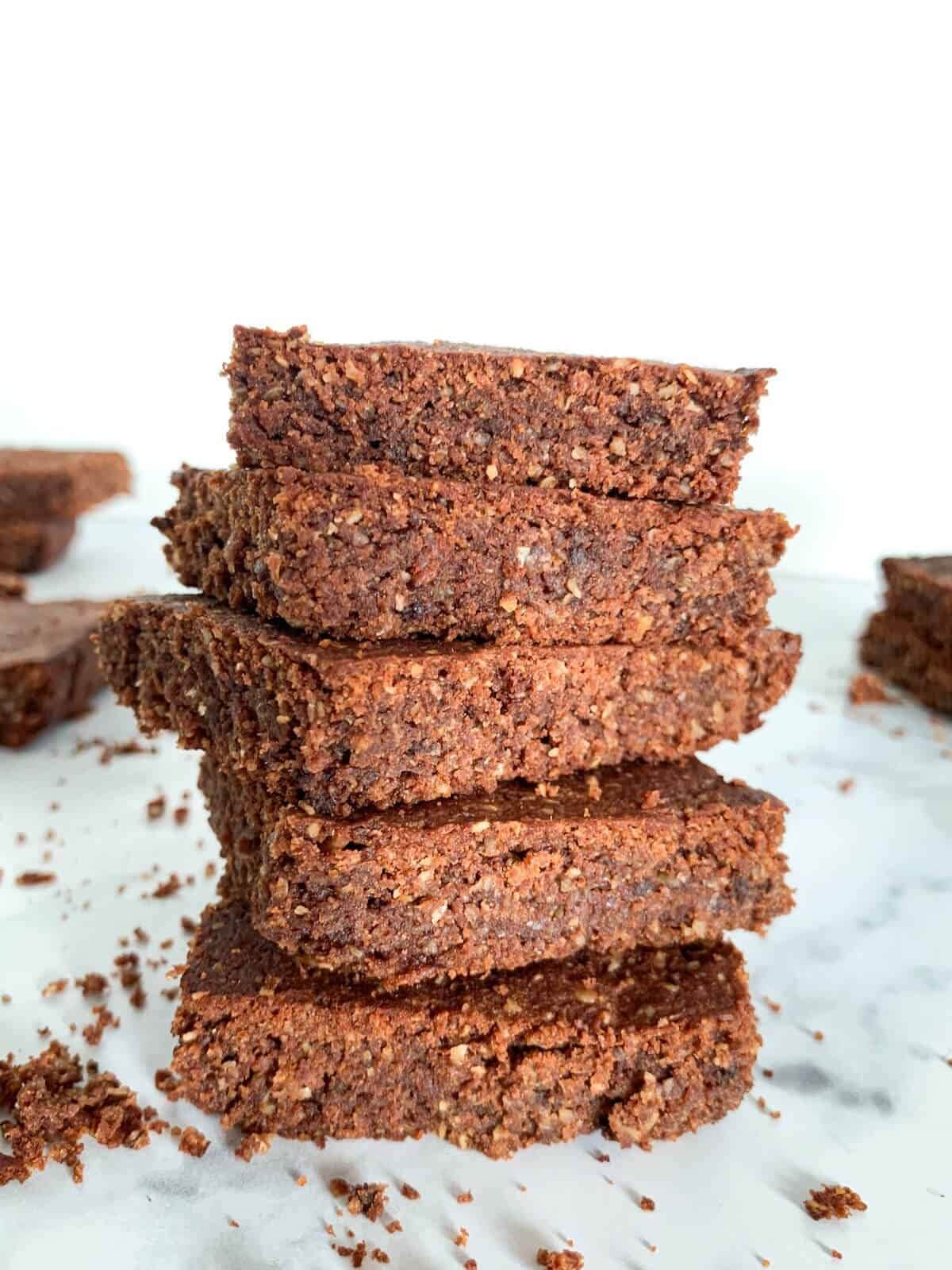 Five sweet potato brownies on top of each other on a white plate. 