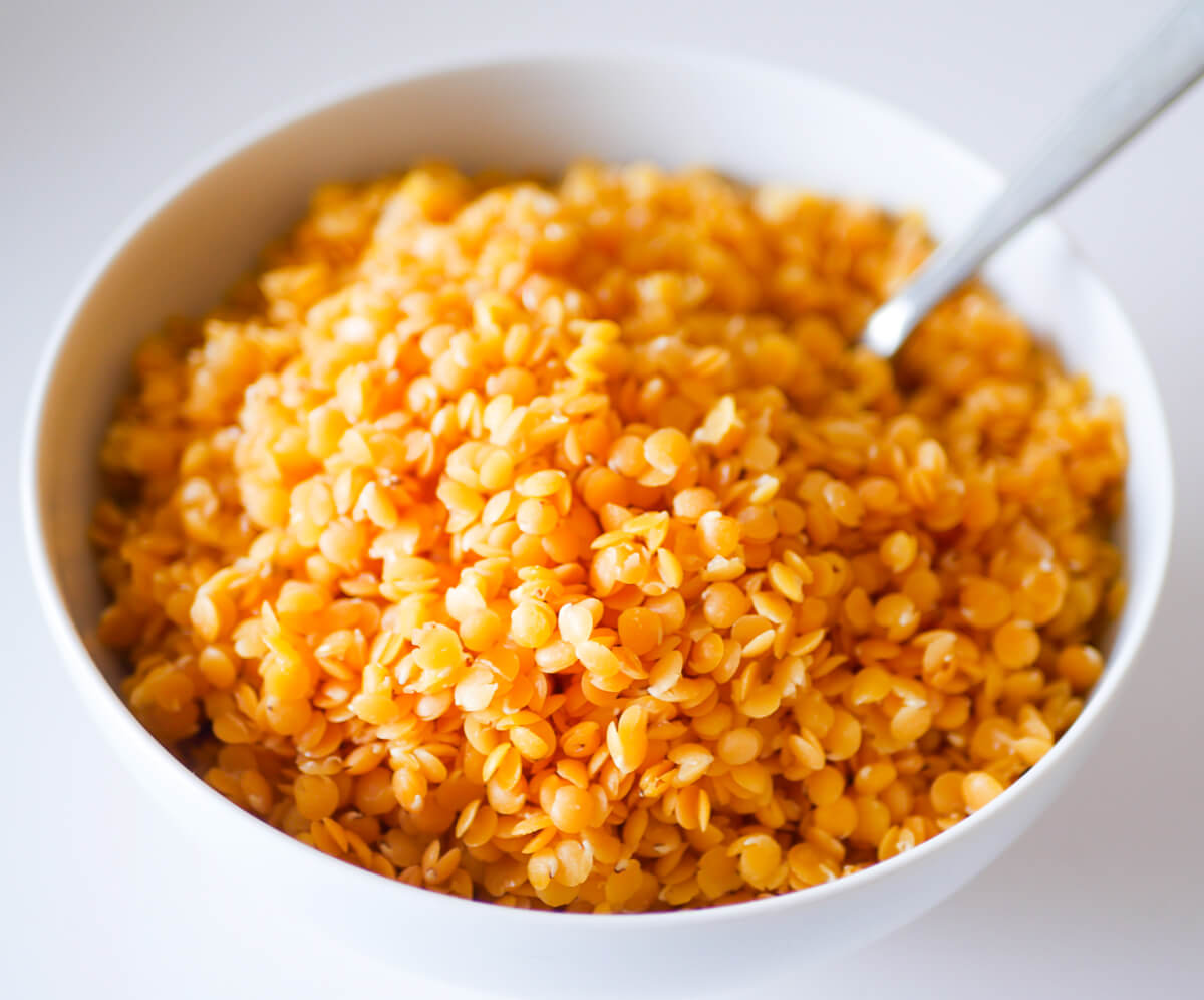 close up of cooked red lentils in a bowl