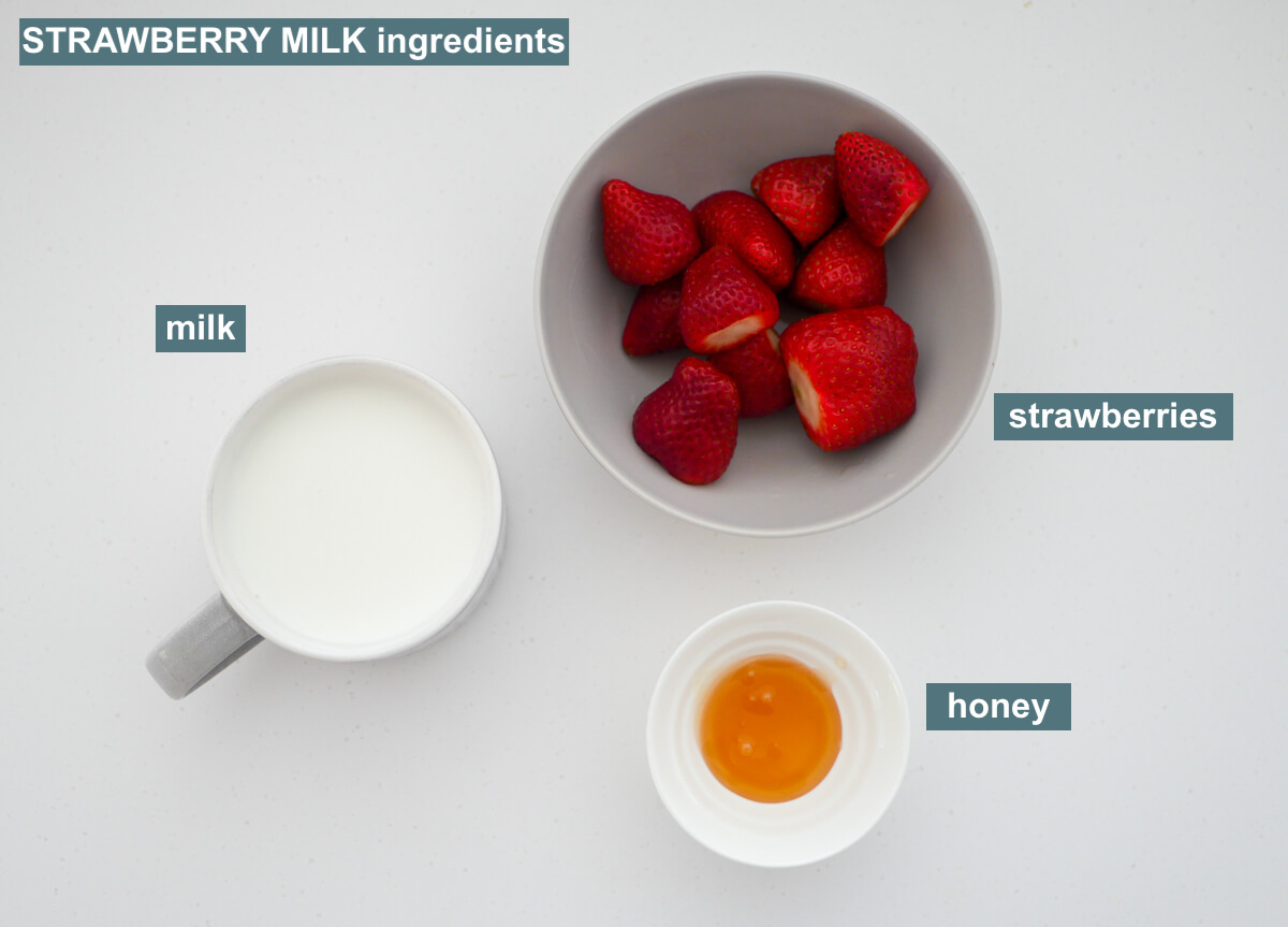 ingredients on white background labeled - strawberries, milk, honey