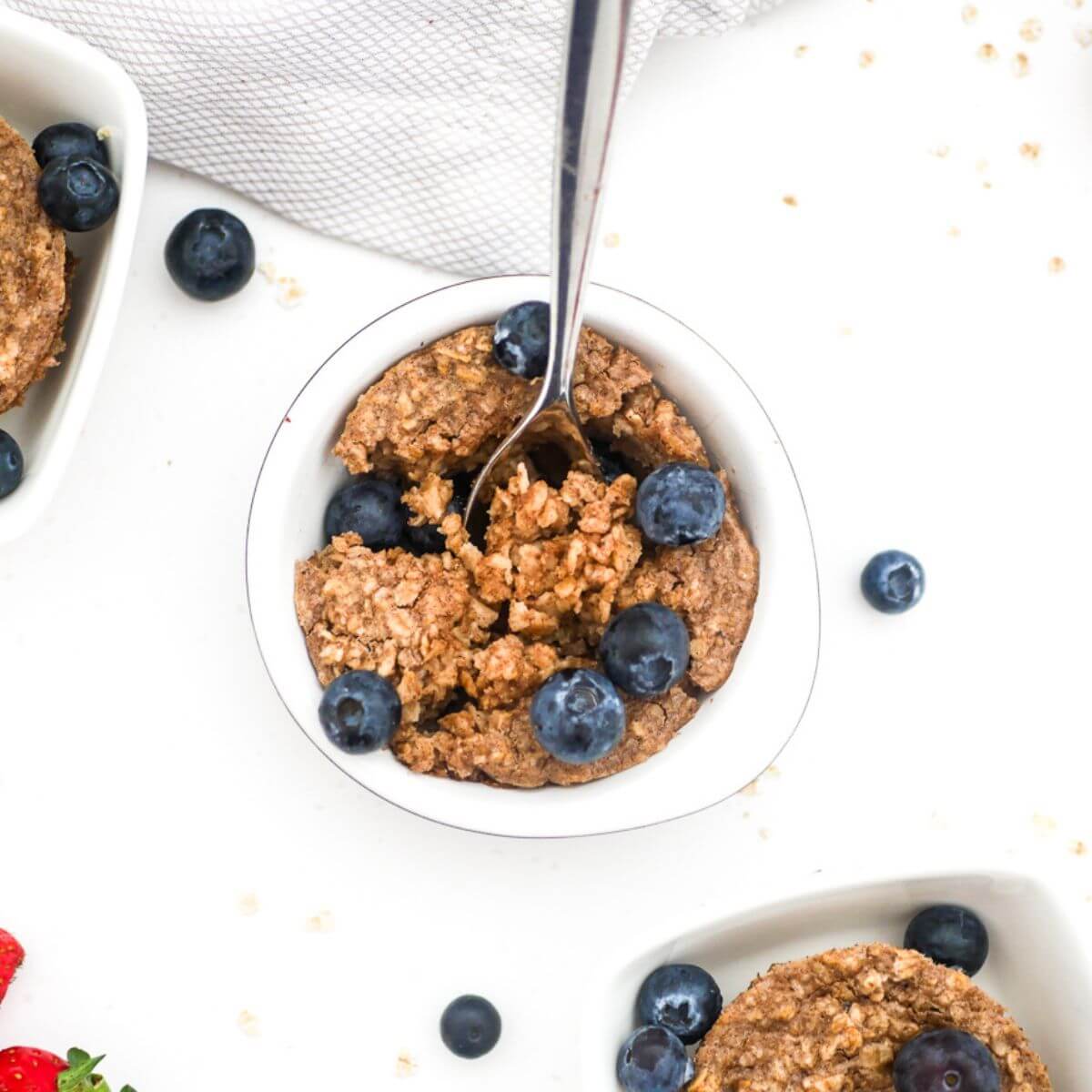 baked oats with no banana in a ramekin topped with blueberries