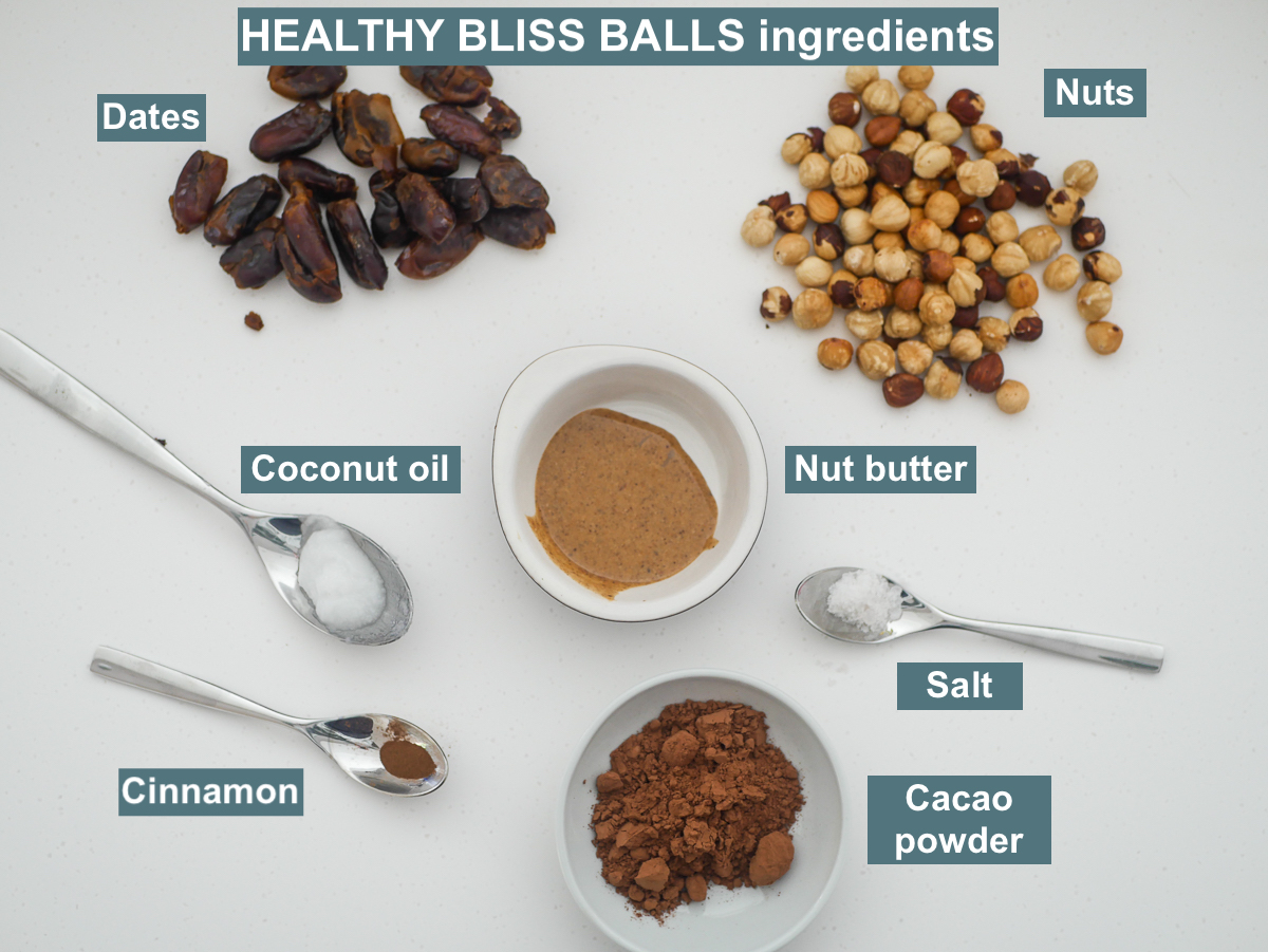 ingredients on white backrgound - nuts, nut butter, dates, coconut oil, cinnamon, cacao powder 