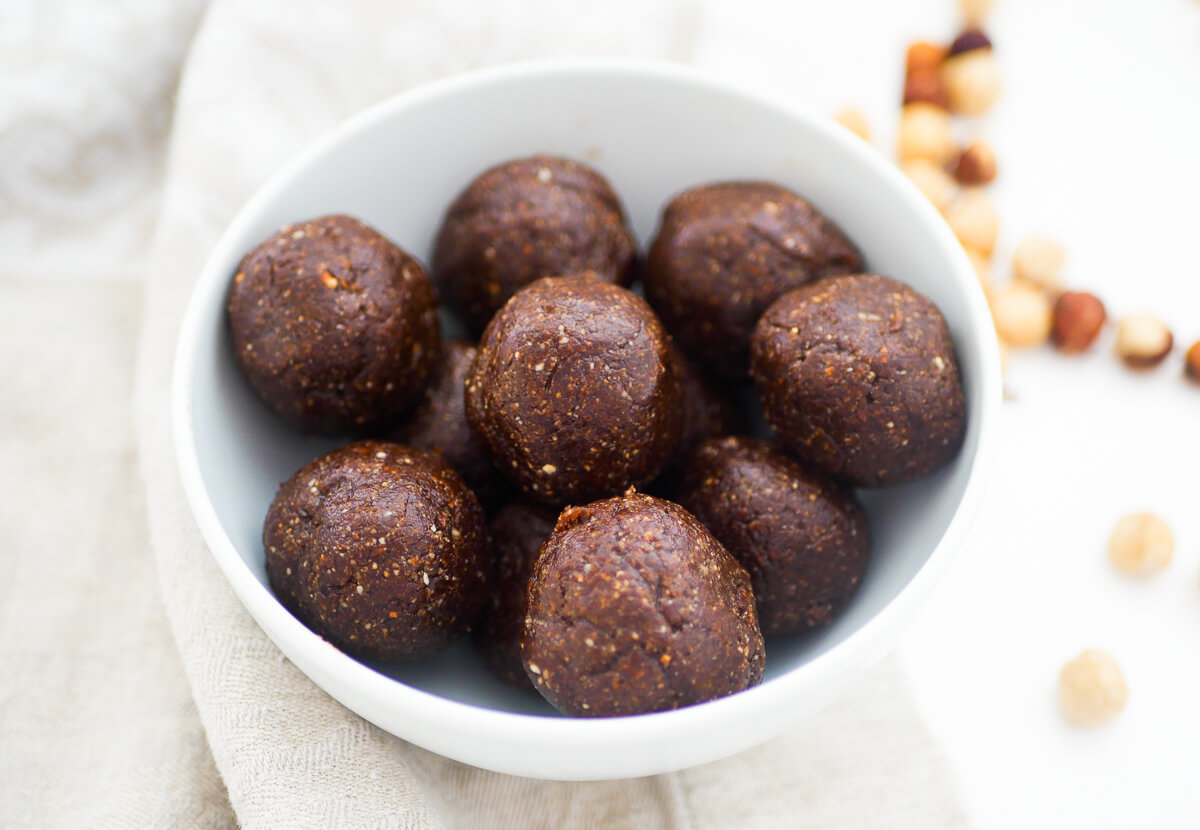 chocolate bliss balls in a white bowl 