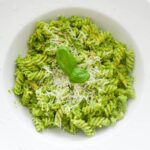 close up of tuna pesto pasta with parmesan cheese