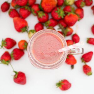 top down image of the strawberry banana milkshake with a spoon dipped in