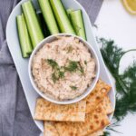 portrait photo of a plate with tuna pate, cucumber spears and crackers