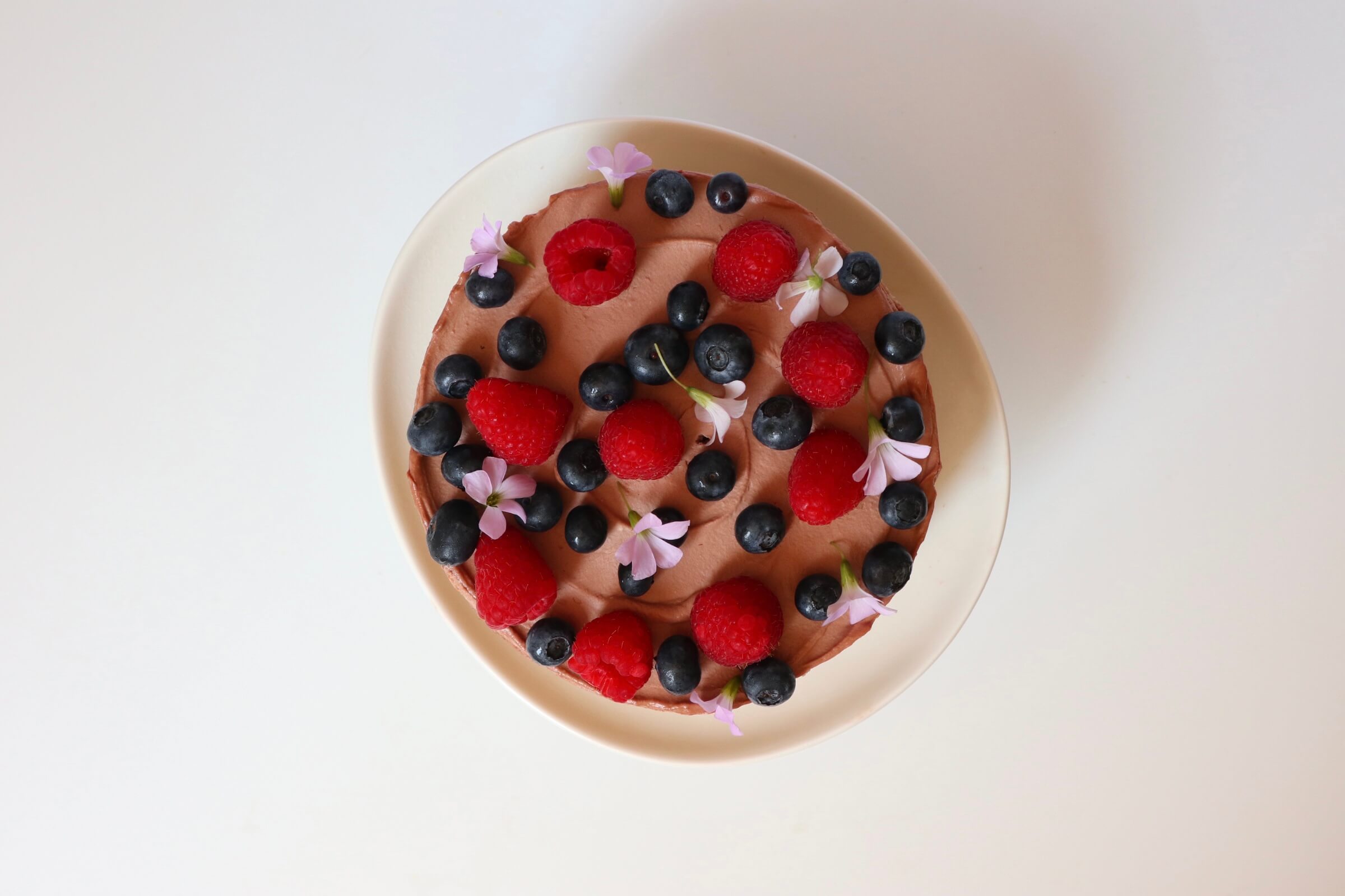 top down image of cake decorated with berries