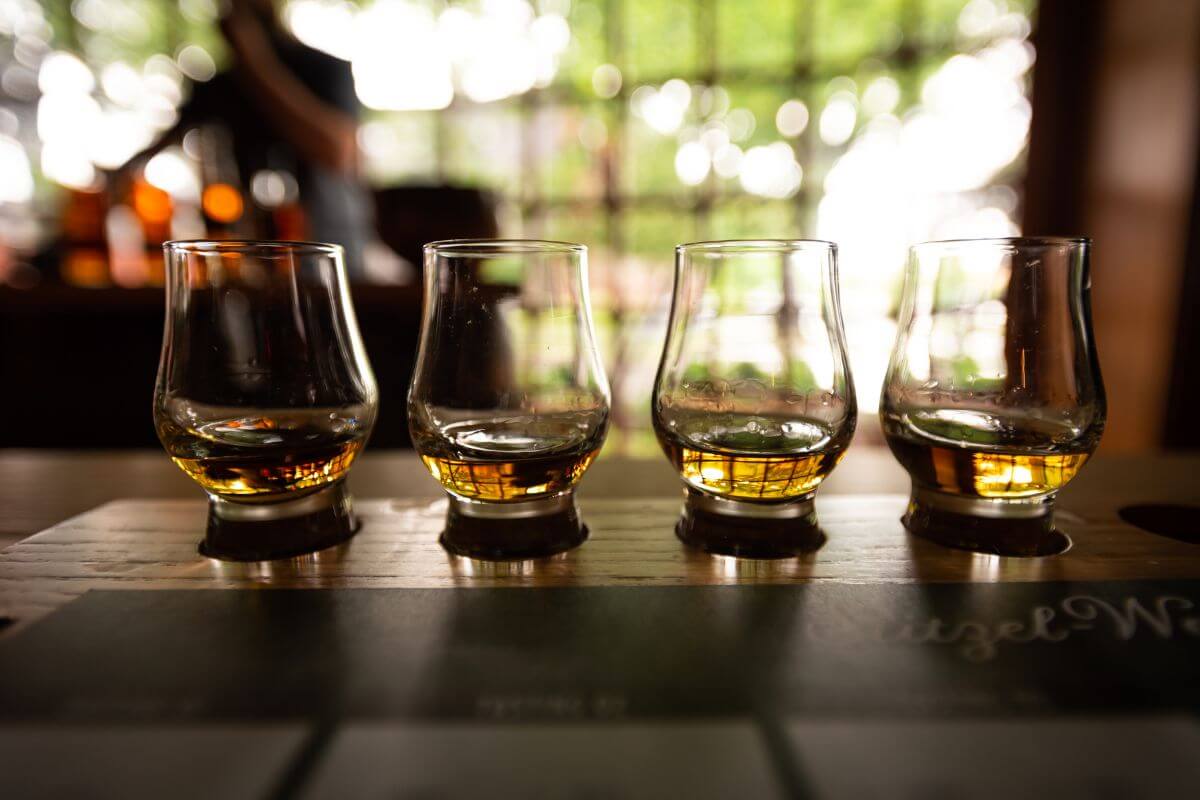 4 glasses of Kentucky Bourbon lined up on a bar